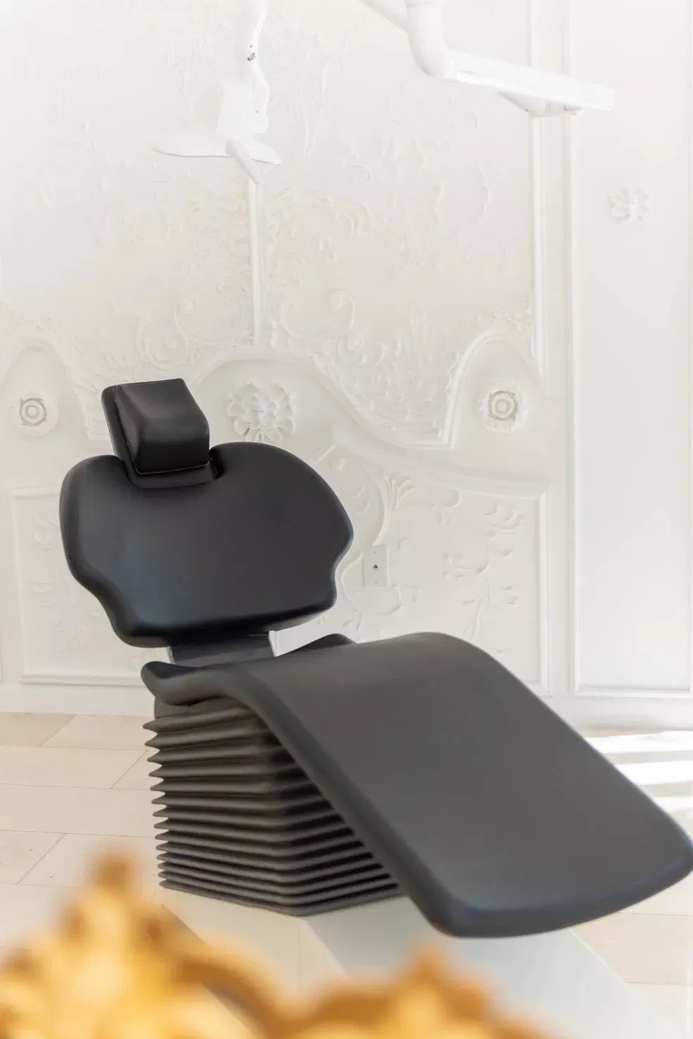 The image shows a modern barber shop chair with an attached sink, situated in a clean, well-lit room, likely a salon or barbershop interior.